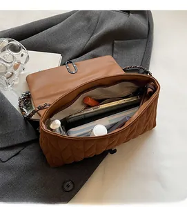 Top view of brown quilted bag interior with zip pocket, spacious enough for daily essentials