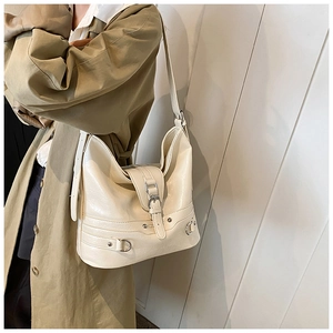 Chic cream PU leather shoulder bag with buckle flap and adjustable strap on a model
