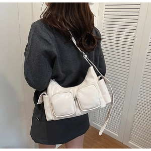 Detail of off-white multi-pocket PU leather shoulder bag with adjustable strap and zippers