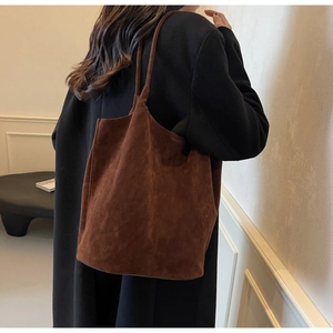 Detailed close-up of dark brown matte PU leather tote bag with long shoulder straps