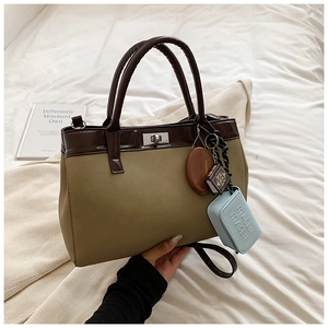 Minimalist PU leather crossbody bag with two-tone stitching and decorative pendants