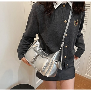 Detail of silver metallic PU crossbody bag with multi-pocket design and adjustable strap