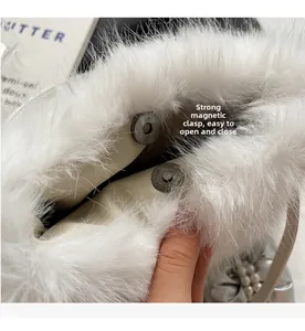 Detail view of the strong magnetic closure and plush white faux fur on this stylish bag
