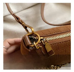 Detail view of brown matte PU shoulder bag with vintage gold hardware and chain strap