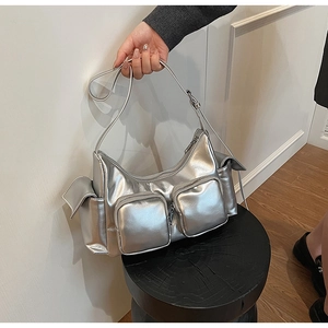 Close-up of metallic silver Y2K style PU leather shoulder bag with multiple zip pockets