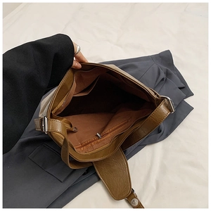 Detail view of brown PU leather shoulder bag interior with multi-functional pockets