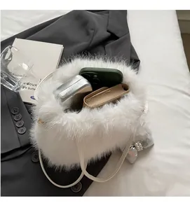 Detailed interior of a white plush shoulder bag showing large capacity and pearl charm