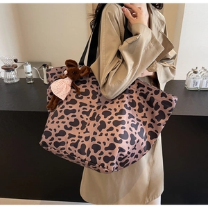 Detail of leopard print tote bag with cute mouse charm on high-density canvas material