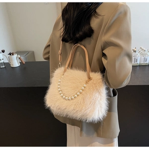 Close-up of plush beige crossbody bag with premium pearl chain handle and leather strap