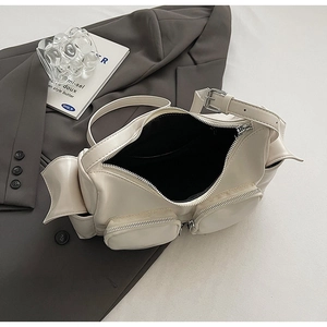 Detail view of cream PU shoulder bag with dual zipper pockets and adjustable strap