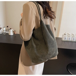 Detail view of deep green suede PU leather tote bag with long shoulder straps for daily use