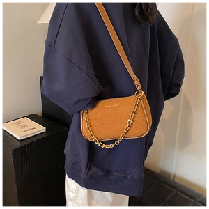 Brown crocodile texture shoulder bag with gold chain strap and curved silhouette
