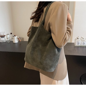 Detail of olive green suede tote bag showing thick texture and large shoulder strap