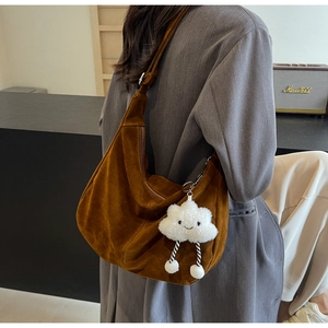 Detail of dark brown matte PU leather hobo bag with cute white cloud plush pendant accessory