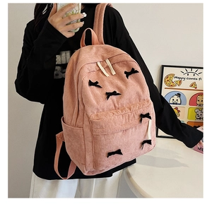 Sac à dos en velours rose avec petit nœud noir et poche latérale pour gourde d'eau