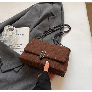 Brown quilted PU leather crossbody bag with V-shaped stitching and chain strap