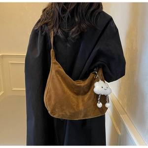 Brown PU hobo shoulder bag with plush cloud charm accessory shown from a back view
