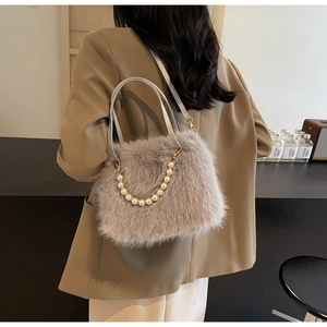 Detail showing plush faux fur texture and decorative pearl chain on the grey shoulder bag