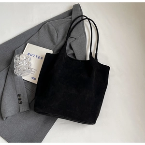 Minimalist black PU leather tote bag with matte texture and long shoulder straps