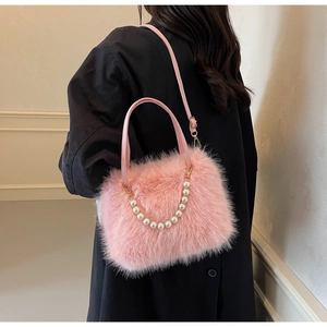 Plush faux fur crossbody bag in pink with elegant pearl handle and slim shoulder strap