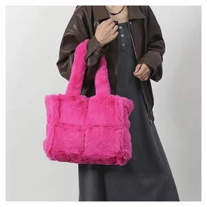 Chic hot pink plush tote bag with checkered stitching detail shown on shoulder