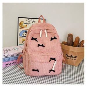 Sac à dos en velours rose avec nœuds noirs et plusieurs poches de rangement