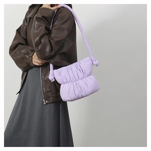 Detail view of light purple pleated puffy nylon shoulder bag with thick knotted strap