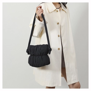 Fashionable black pleated puffer bucket bag with adjustable shoulder strap and knot design