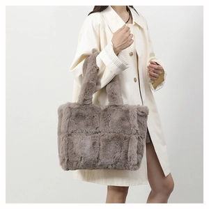 Detailed close-up of textured plush tote bag with checkerboard stitching and soft faux fur