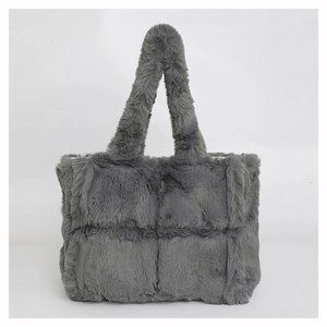Detailed view of grey faux fur tote bag showing plush square quilted texture and soft handle