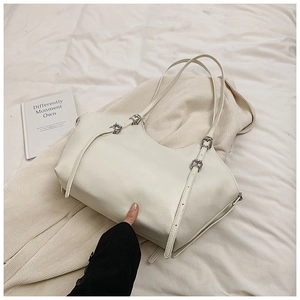 Chic cream PU leather tote bag with metallic buckle detail on soft textured background