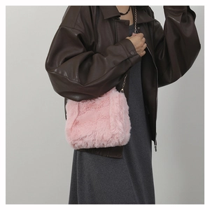 Detailed view of pink faux fur crossbody bag with soft texture and silver chain strap