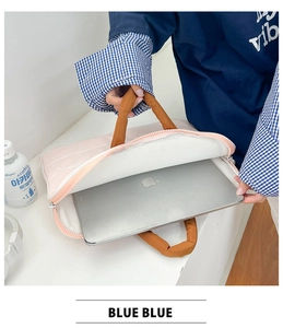 Pink and orange laptop sleeve showing a 13-inch silver laptop inside with zipper open