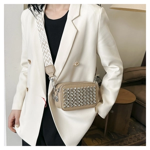 Detail of khaki PU leather crossbody bag featuring silver metal studs and jacquard strap