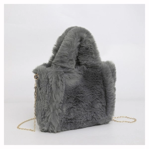 Detail of grey faux fur tote bag showing plush texture and gold metal chain strap