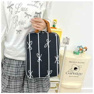 Minimalist navy blue laptop tote bag with white vertical stripes and brown handles