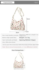 Detail view of corduroy shoulder bag featuring red strawberry print and zipper pockets
