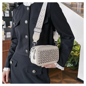 Detail view of cream white PU leather crossbody bag with sparkling silver rhinestones