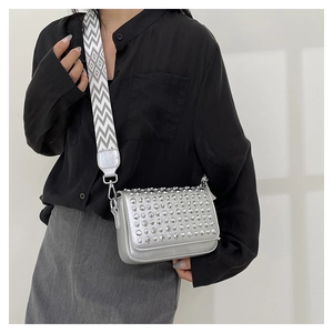 Silver PU leather shoulder bag with metallic rivets and a woven geometric wide strap