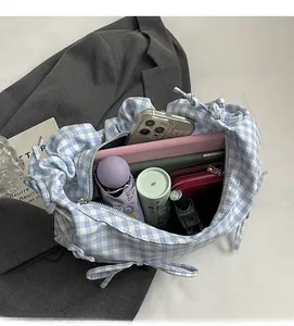 Detailed view of spacious blue gingham tote bag showing large capacity for daily items