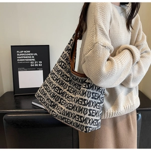 Detailed close-up of knit tote bag showing ZENXIN floral pattern and leather piping