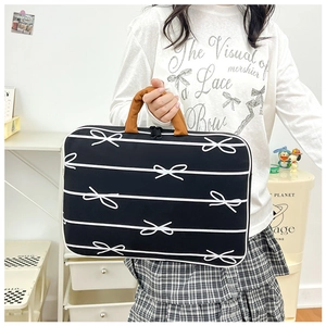 Chic black fabric laptop handbag with white bow patterns and brown handles for women
