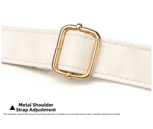 Close-up of cream white leather shoulder strap with adjustable gold metal buckle