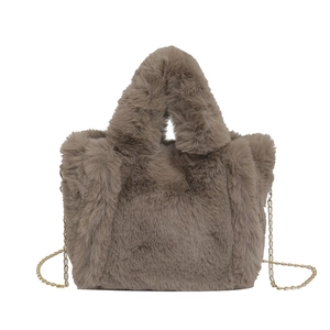 Brown plush faux fur crossbody bag with golden chain strap and soft top handle