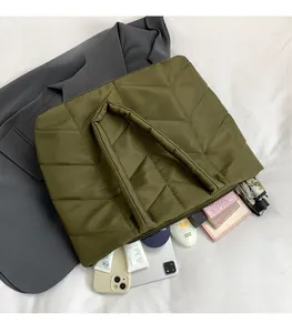 Detail view of large olive green quilted nylon shoulder bag with spacious interior capacity