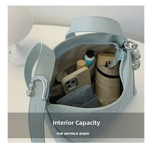 Spacious interior of light blue woven PU shoulder bag showing daily essentials
