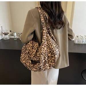 Detailed macro view of large leopard print tote bag with wide soft shoulder straps