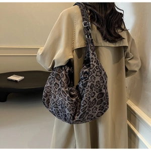 Detail of grey leopard print hobo bag showing large capacity and adjustable metal buckle