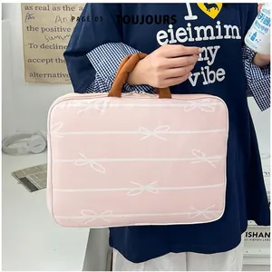 Pink bow-patterned 14-inch laptop sleeve bag with thick brown handles and dual zippers
