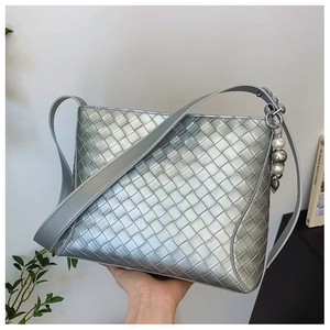 Silver woven PU leather shoulder bag with pearl pendant and minimalist metallic texture